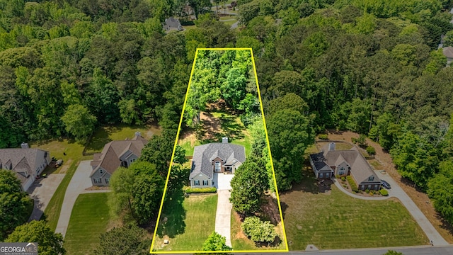 aerial perspective of suburban area with a forest and property boundaries highlighted