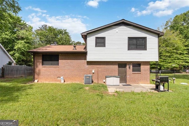 2469 Silver King Dr, Grayson, GA 30017 - rear view of house with fence, brick siding, a patio area, central air condition unit, and a lawn