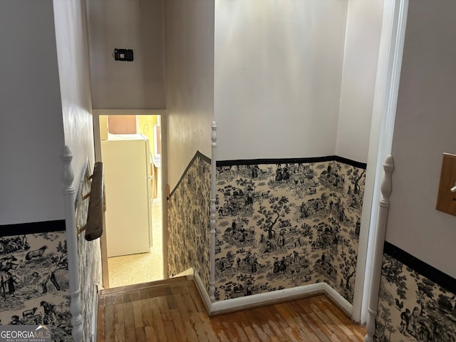 stairway with wood finished floors