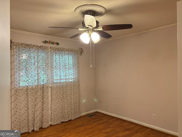 spare room featuring crown molding, baseboards, a ceiling fan, and wood finished floors