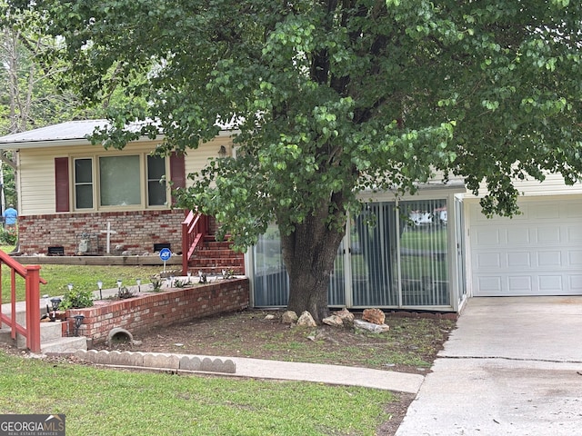 view of front of property with brick siding, an attached garage, and concrete driveway