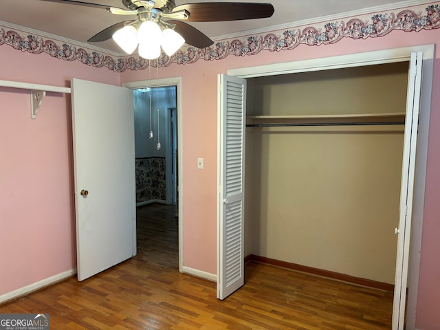 unfurnished bedroom with baseboards, ceiling fan, a closet, and wood finished floors