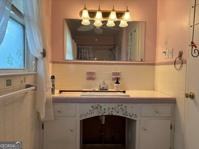 full bathroom featuring tile walls, curtained shower, and vanity