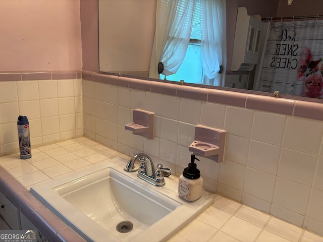 bathroom featuring vanity and backsplash