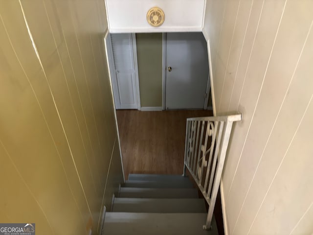 stairs featuring wood finished floors