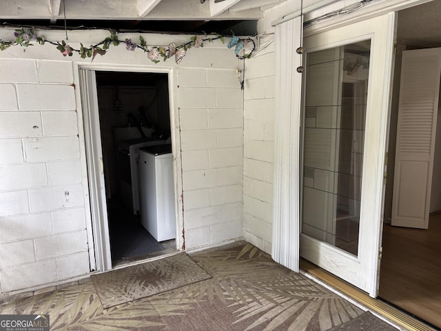 interior space featuring washer / clothes dryer and concrete block wall