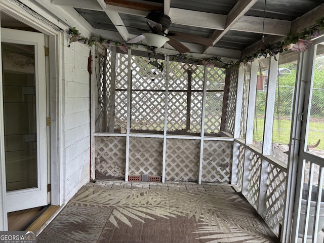 unfurnished sunroom featuring ceiling fan