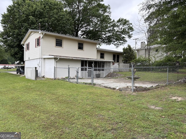back of property featuring fence and a yard