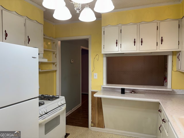kitchen featuring white appliances, crown molding, white cabinets, and light countertops