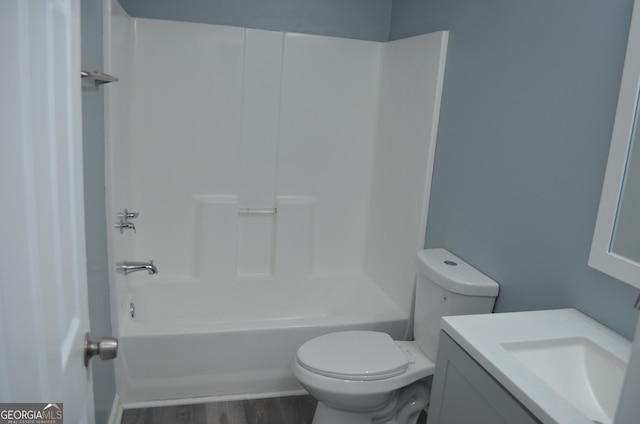 full bathroom featuring vanity,  shower combination, wood finished floors, and toilet