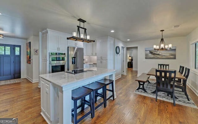 kitchen featuring an inviting chandelier, dark wood-style floors, recessed lighting, white cabinetry, and appliances with stainless steel finishes