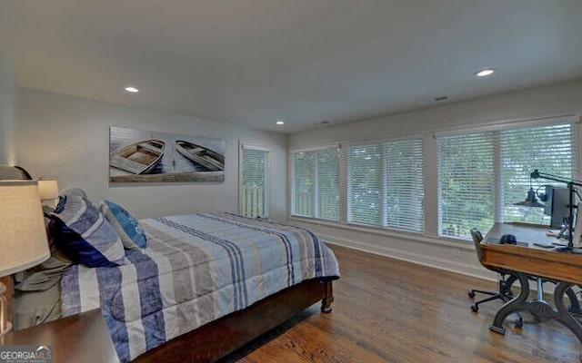 bedroom featuring baseboards, multiple windows, recessed lighting, and wood finished floors