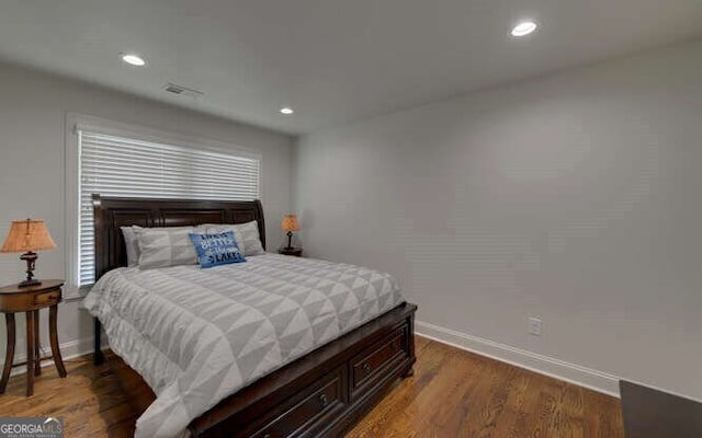 bedroom featuring baseboards, recessed lighting, wood finished floors, and visible vents