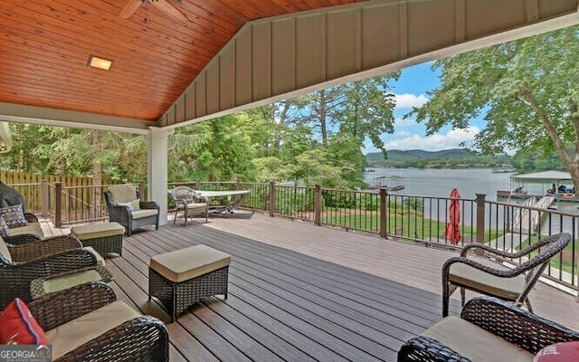 wooden deck with an outdoor hangout area and a water view