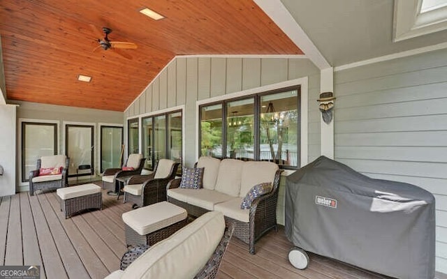 wooden terrace with an outdoor living space, a ceiling fan, and a grill