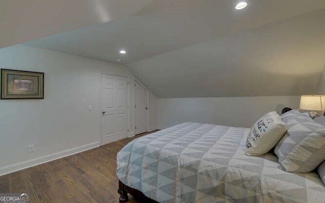 bedroom featuring baseboards, recessed lighting, lofted ceiling, and wood finished floors