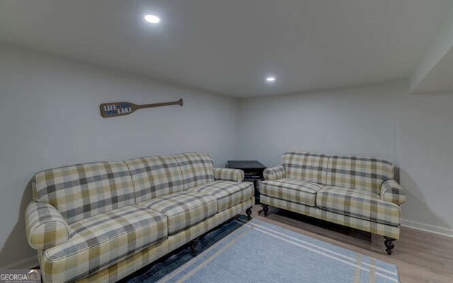 living area featuring recessed lighting, baseboards, and wood finished floors