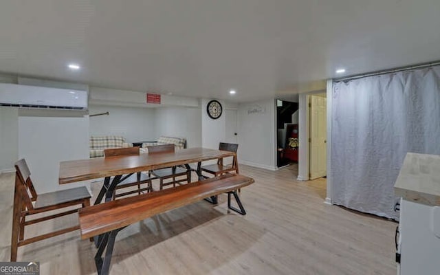 dining area with an AC wall unit, recessed lighting, and light wood-style flooring