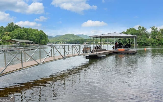 view of dock with a water and mountain view