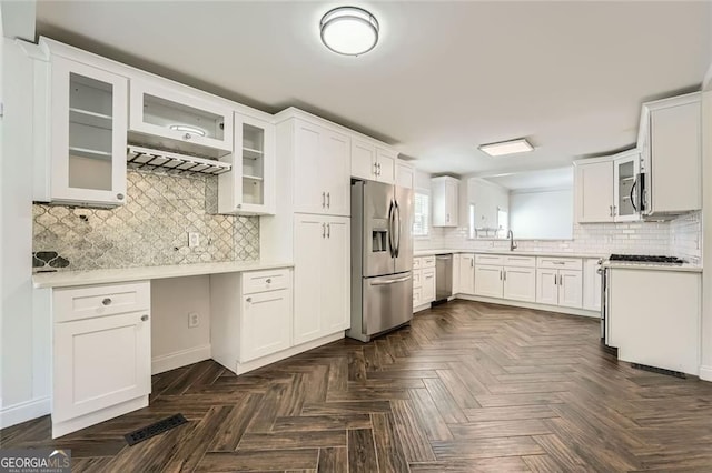 632 Warren Ave, Scottdale, GA 30079 - kitchen with glass insert cabinets, white cabinets, backsplash, light countertops, and appliances with stainless steel finishes