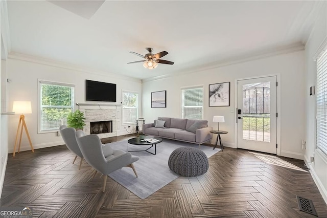 632 Warren Ave, Scottdale, GA 30079 - living room with crown molding, visible vents, baseboards, a stone fireplace, and ceiling fan