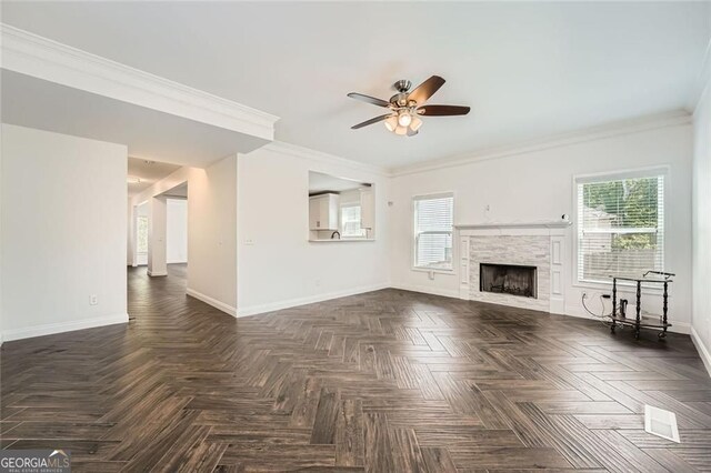 632 Warren Ave, Scottdale, GA 30079 - unfurnished living room featuring baseboards, crown molding, a healthy amount of sunlight, and ceiling fan