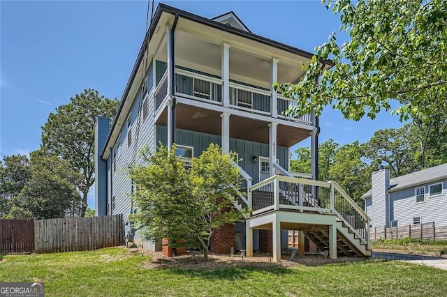 632 Warren Ave, Scottdale, GA 30079 - back of property featuring board and batten siding, fence, stairs, a balcony, and a lawn