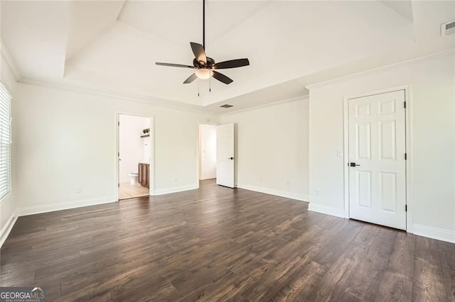 632 Warren Ave, Scottdale, GA 30079 - unfurnished bedroom with a tray ceiling, ornamental molding, baseboards, and dark wood-type flooring