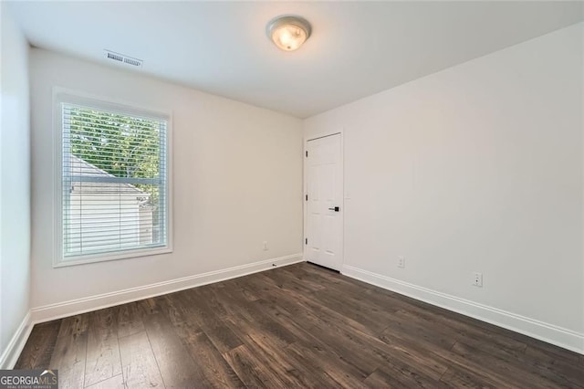 632 Warren Ave, Scottdale, GA 30079 - spare room featuring baseboards, dark wood-style floors, and visible vents
