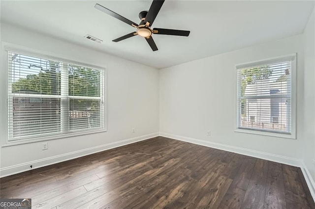 632 Warren Ave, Scottdale, GA 30079 - empty room featuring visible vents, a ceiling fan, a healthy amount of sunlight, and dark wood-style floors