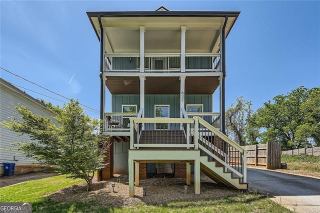 632 Warren Ave, Scottdale, GA 30079 - exterior space featuring covered porch, fence, a balcony, stairway, and board and batten siding