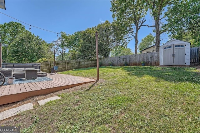 632 Warren Ave, Scottdale, GA 30079 - view of yard featuring an outdoor structure, a deck, a storage unit, a fenced backyard, and an outdoor hangout area