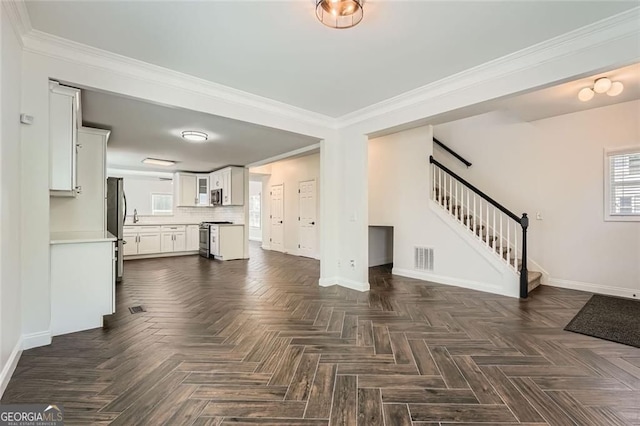 632 Warren Ave, Scottdale, GA 30079 - unfurnished living room featuring baseboards, stairs, and visible vents