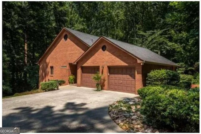 5325 Pheasant Run, Stone Mountain, GA 30087 - view of front of home featuring a view of trees, driveway, and a garage