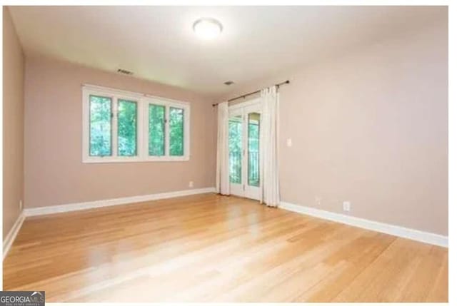 5325 Pheasant Run, Stone Mountain, GA 30087 - unfurnished room featuring baseboards and light wood-style flooring