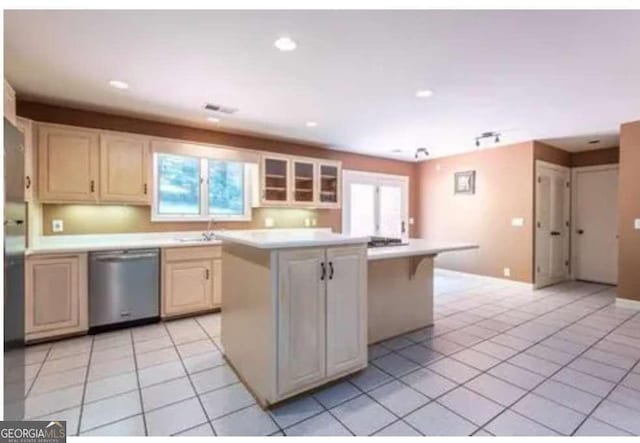 5325 Pheasant Run, Stone Mountain, GA 30087 - kitchen featuring light countertops, stainless steel dishwasher, a kitchen island, and light tile patterned flooring