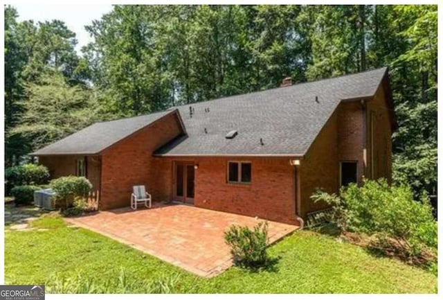 5325 Pheasant Run, Stone Mountain, GA 30087 - rear view of property with a patio, a yard, and a chimney