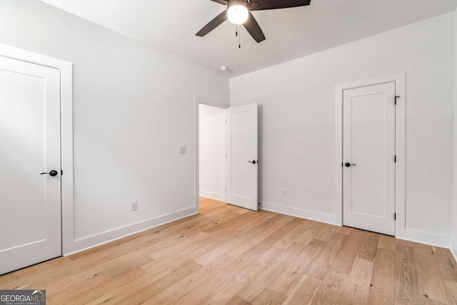 unfurnished bedroom with a ceiling fan, baseboards, and light wood finished floors