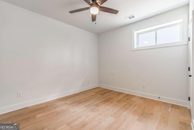 unfurnished room featuring a ceiling fan, baseboards, visible vents, and light wood-style floors