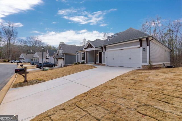ranch-style home with a garage, roof with shingles, a residential view, and concrete driveway