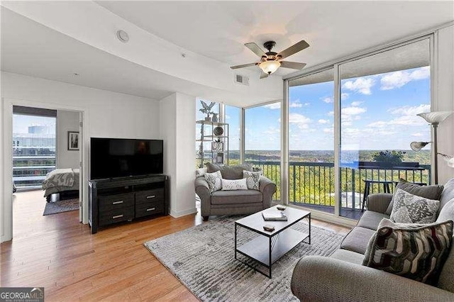 3300 Windy Ridge Parkway SE Unit 1401, Atlanta, GA 30339 - living room featuring visible vents, floor to ceiling windows, ceiling fan, and light wood finished floors