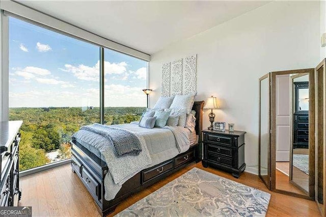 3300 Windy Ridge Parkway SE Unit 1401, Atlanta, GA 30339 - bedroom with wood finished floors and multiple windows