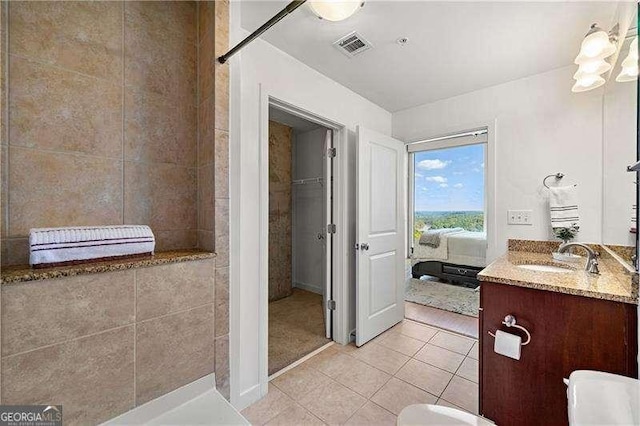 3300 Windy Ridge Parkway SE Unit 1401, Atlanta, GA 30339 - ensuite bathroom featuring connected bathroom, tile patterned flooring, vanity, visible vents, and tiled shower