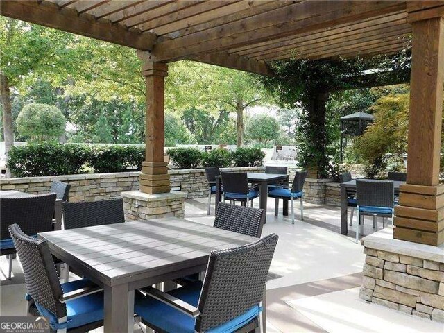 3300 Windy Ridge Parkway SE Unit 1401, Atlanta, GA 30339 - view of patio with a pergola and outdoor dining space