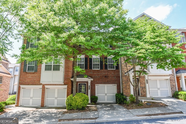 2201 Landing Walk Dr, Duluth, GA 30097 - view of property featuring brick siding, an attached garage, and driveway