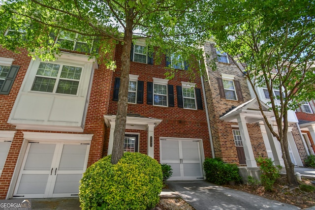 2201 Landing Walk Dr, Duluth, GA 30097 - view of property with a garage, driveway, and brick siding
