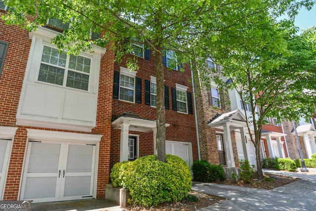 2201 Landing Walk Dr, Duluth, GA 30097 - view of property with brick siding and a garage