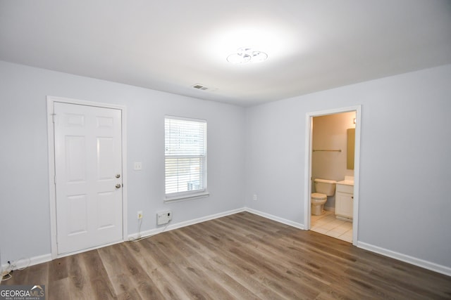 2201 Landing Walk Dr, Duluth, GA 30097 - interior space with visible vents, connected bathroom, baseboards, and wood finished floors