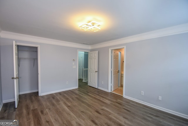 2201 Landing Walk Dr, Duluth, GA 30097 - unfurnished bedroom with baseboards, ornamental molding, wood finished floors, and a closet