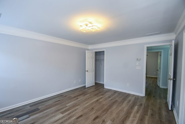 2201 Landing Walk Dr, Duluth, GA 30097 - unfurnished bedroom with baseboards, ornamental molding, dark wood-style floors, and a closet